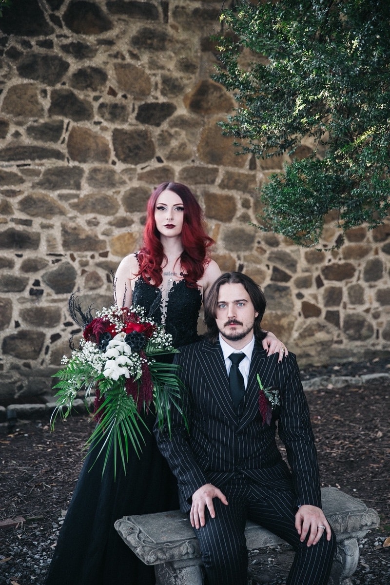 Gothic couple portrait with dark floral bouquet